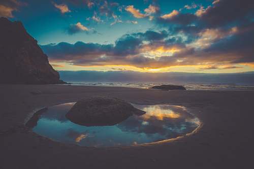 cannon beach rock near body of water lagoon
